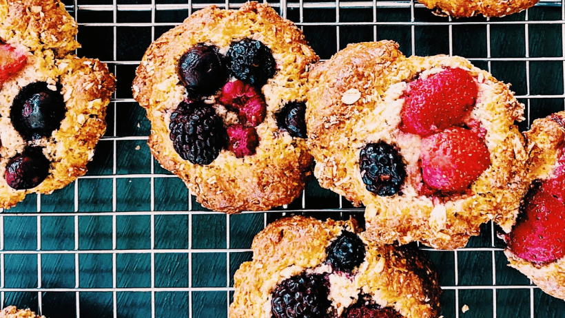 Homemade berry biscuits that are golden with raspberries, blueberries and strawberries baked in on top.